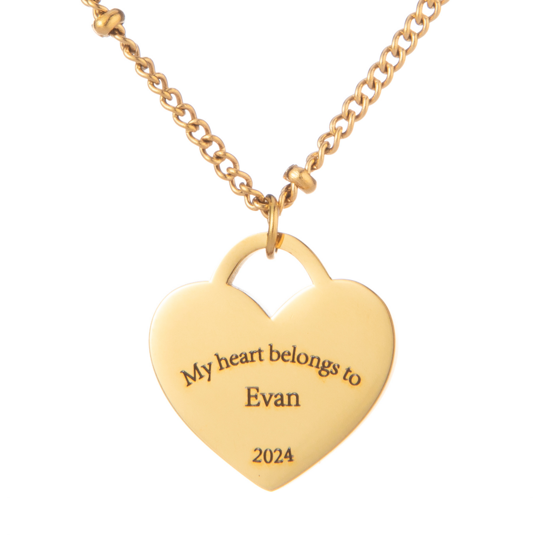 A gold-plated heart-shaped necklace pendant with the engraved message 'My heart belongs to Evan 2024' on a beaded chain.