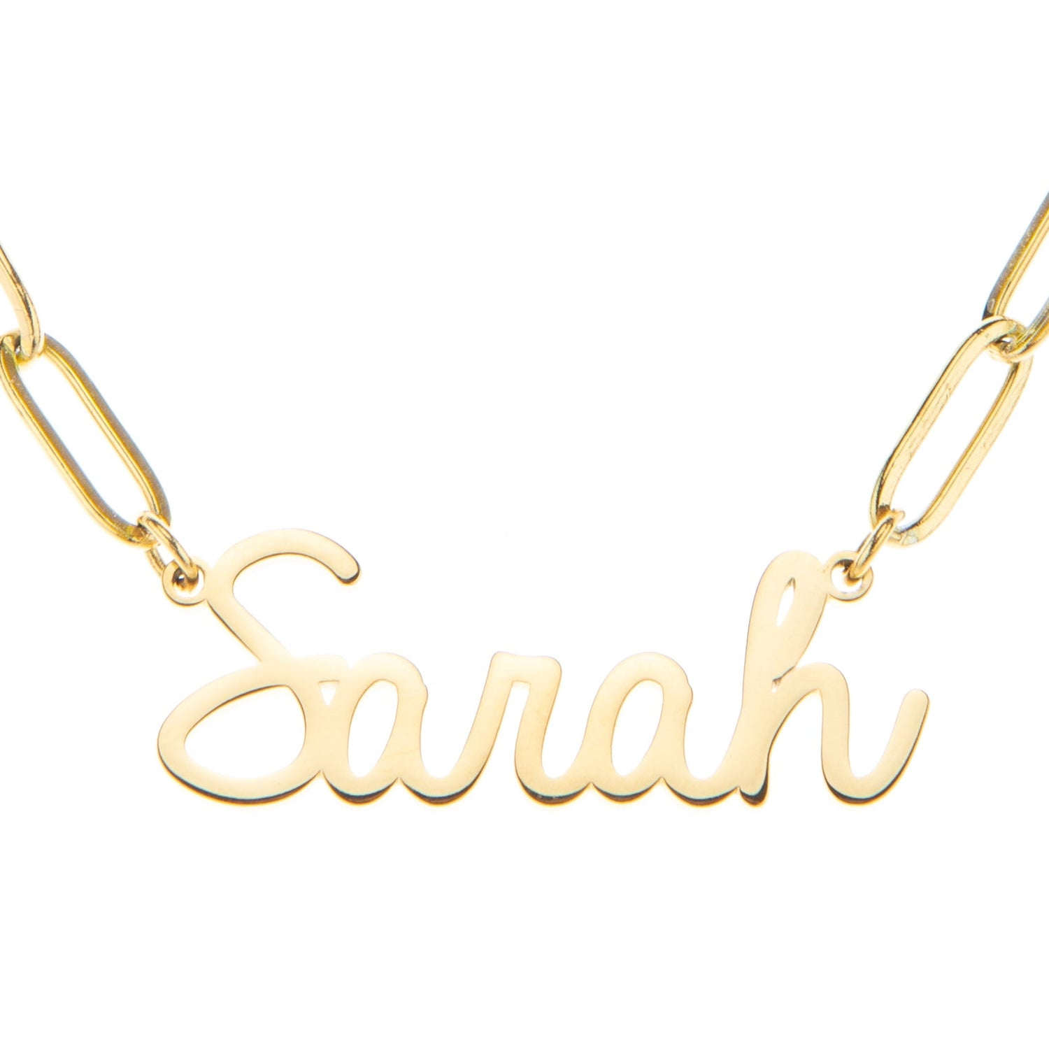 A gold-colored stainless steel chain necklace with a name 'Sarah' written in a cursive font, showing the link chain design.
