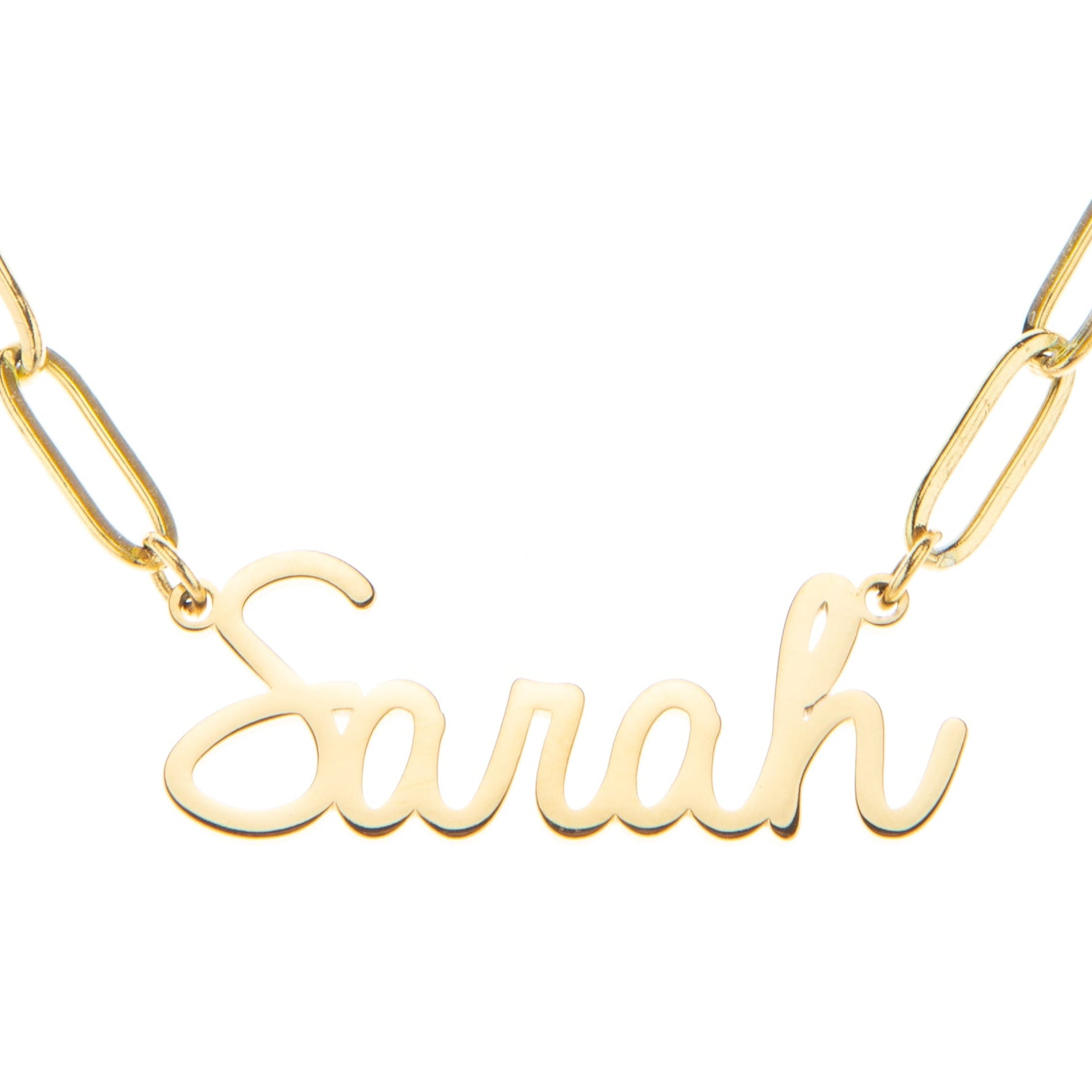 A gold-colored stainless steel chain necklace with a name 'Sarah' written in a cursive font, showing the link chain design.