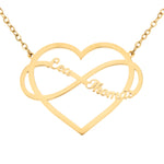 A gold-colored necklace featuring a heart-shaped pendant with an infinity symbol in the center, with the name 'Lea'  and 'Thomas' inscribed on the heart.