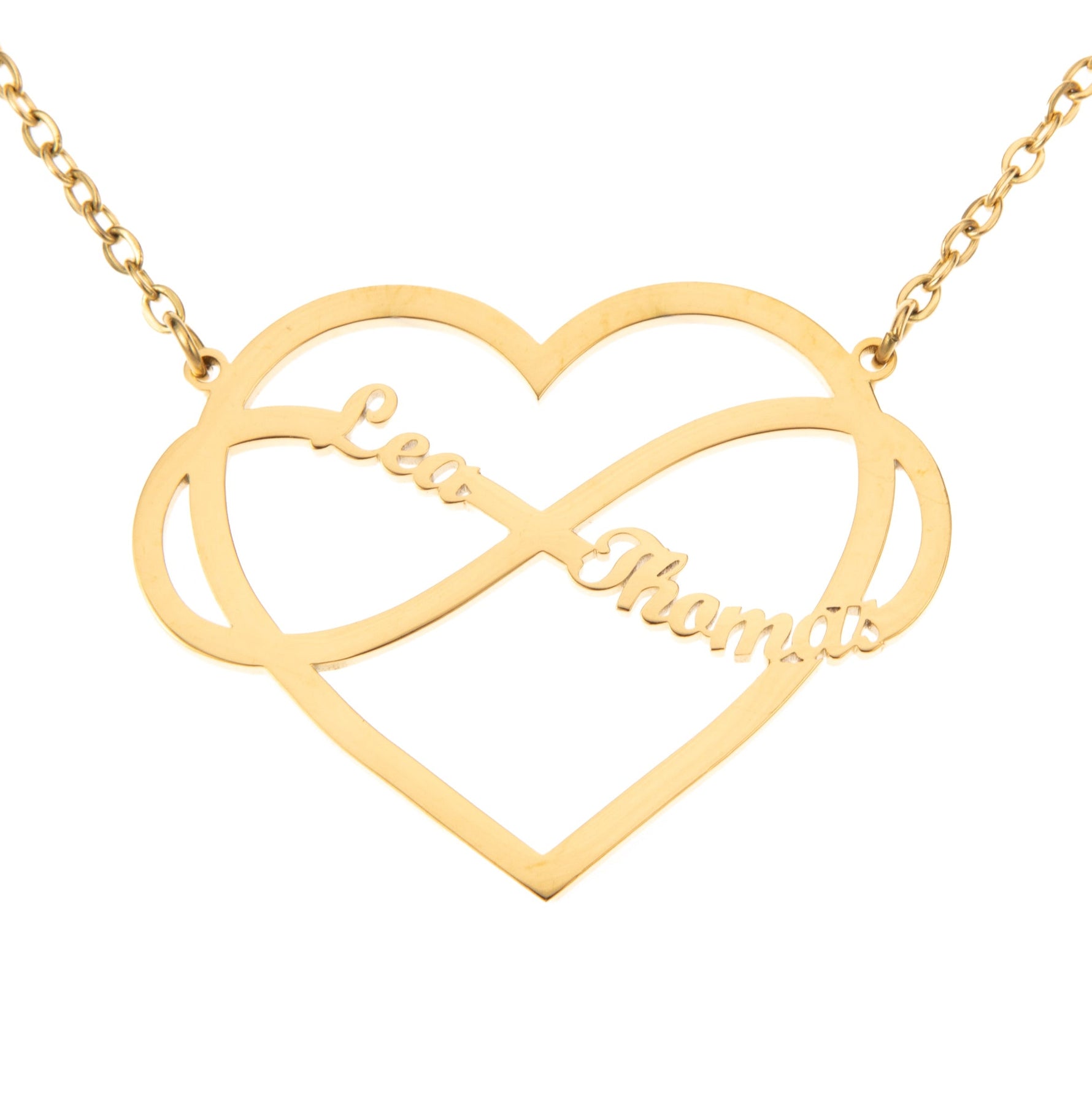 A gold-colored necklace featuring a heart-shaped pendant with an infinity symbol in the center, with the name 'Lea'  and 'Thomas' inscribed on the heart.