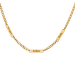 A gold-colored stainless steel necklace with personalized engravings of multiple names.